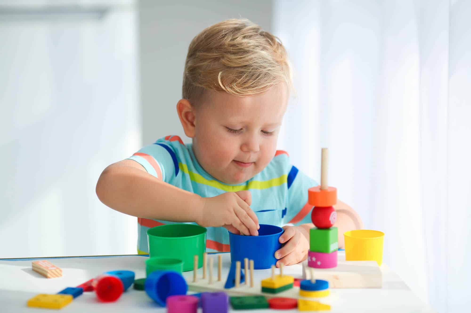 a-little-boy-plays-with-wooden-toys-and-builds-a-t-2023-11-27-05-18-58-utc.jpg