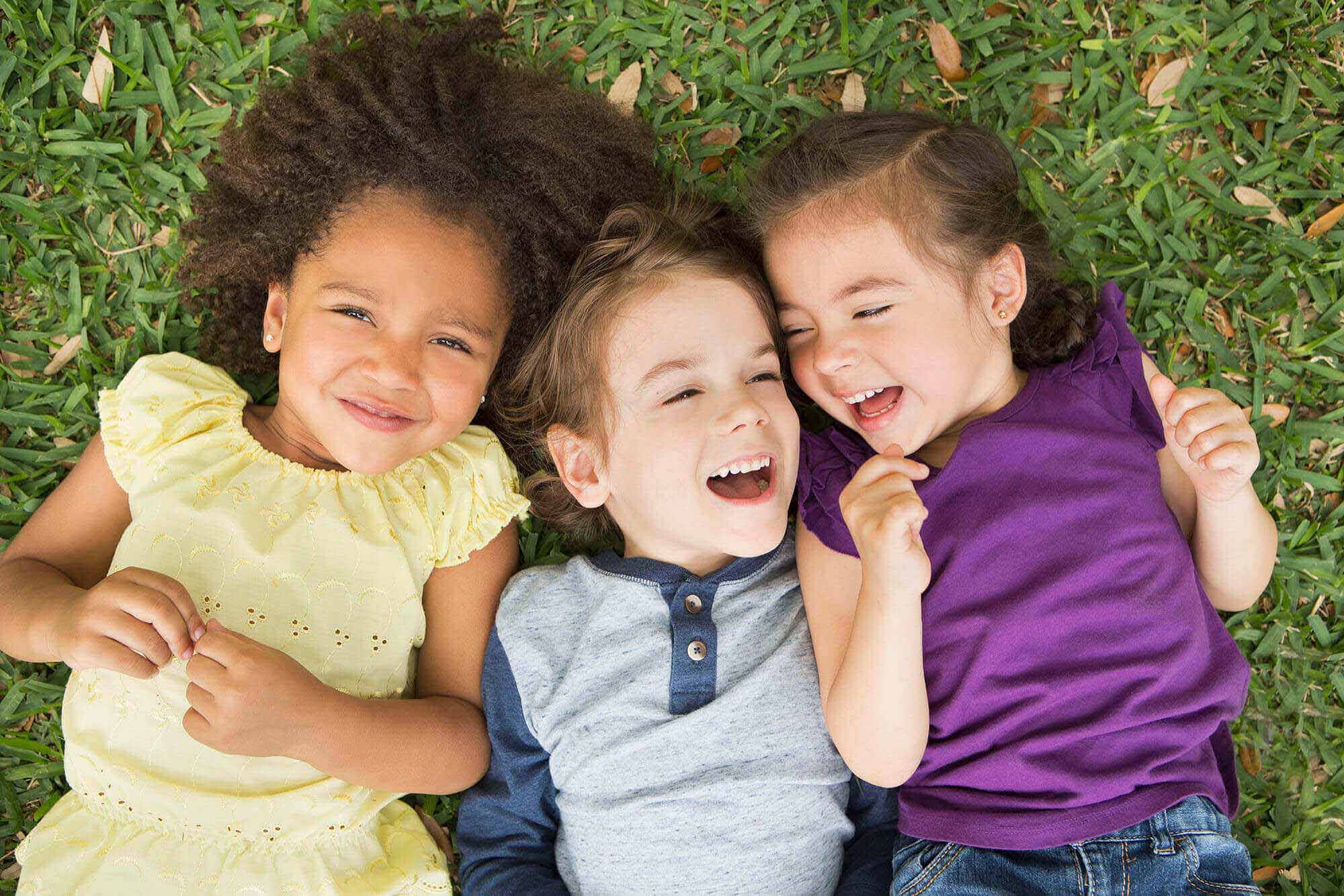 three-children-lying-on-their-backs-on-the-grass-2023-11-27-05-14-52-utc-1.jpg